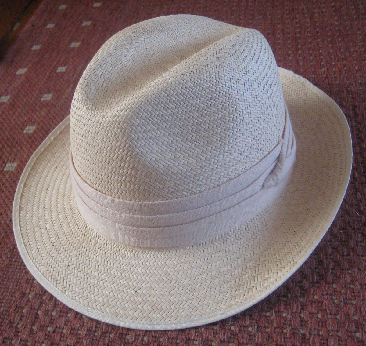 Close-up of a woven straw Panama hat with a cloth band