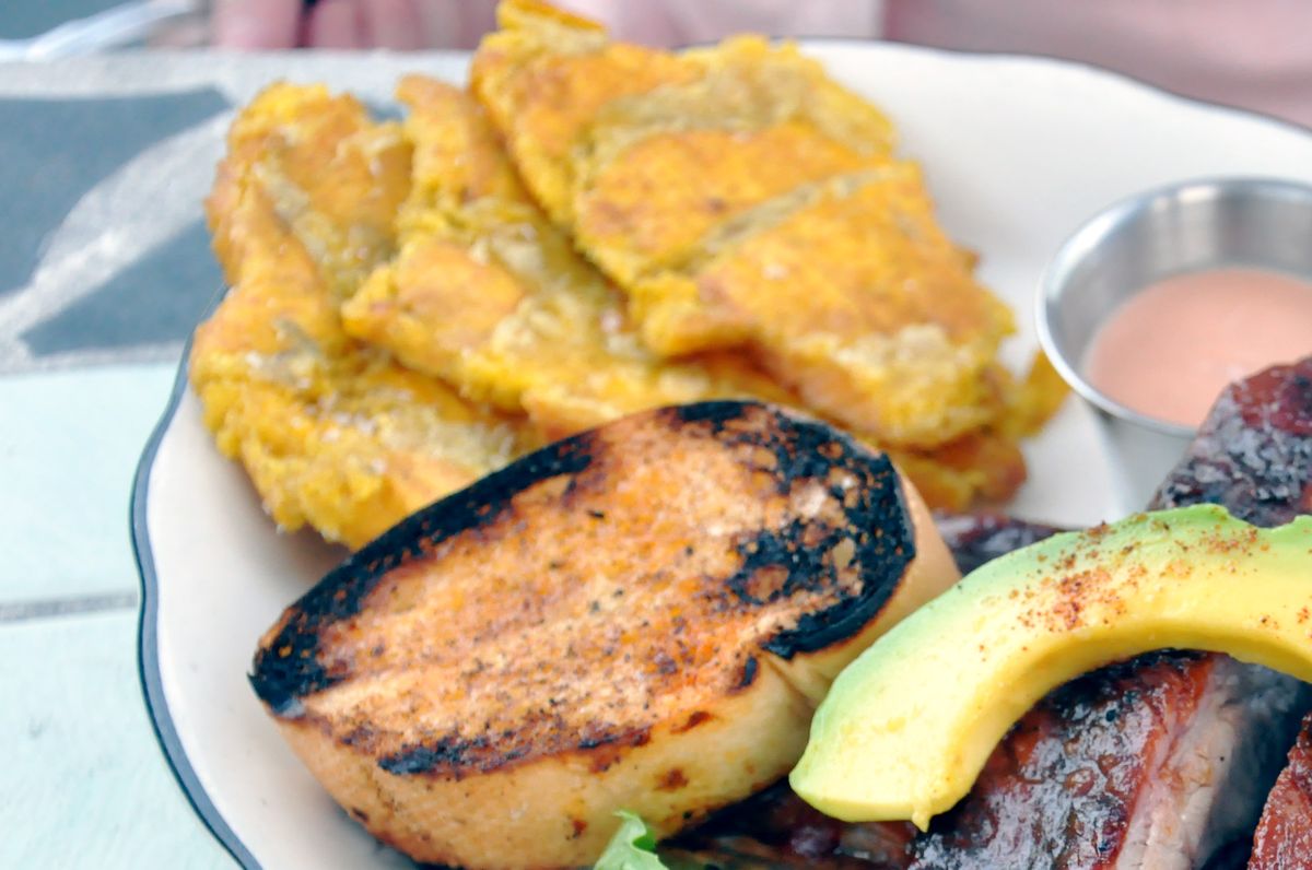 A pile of golden fried tostones (twice-fried plantains) on a plate in Puerto Rico